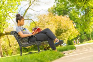girl on park bench reading