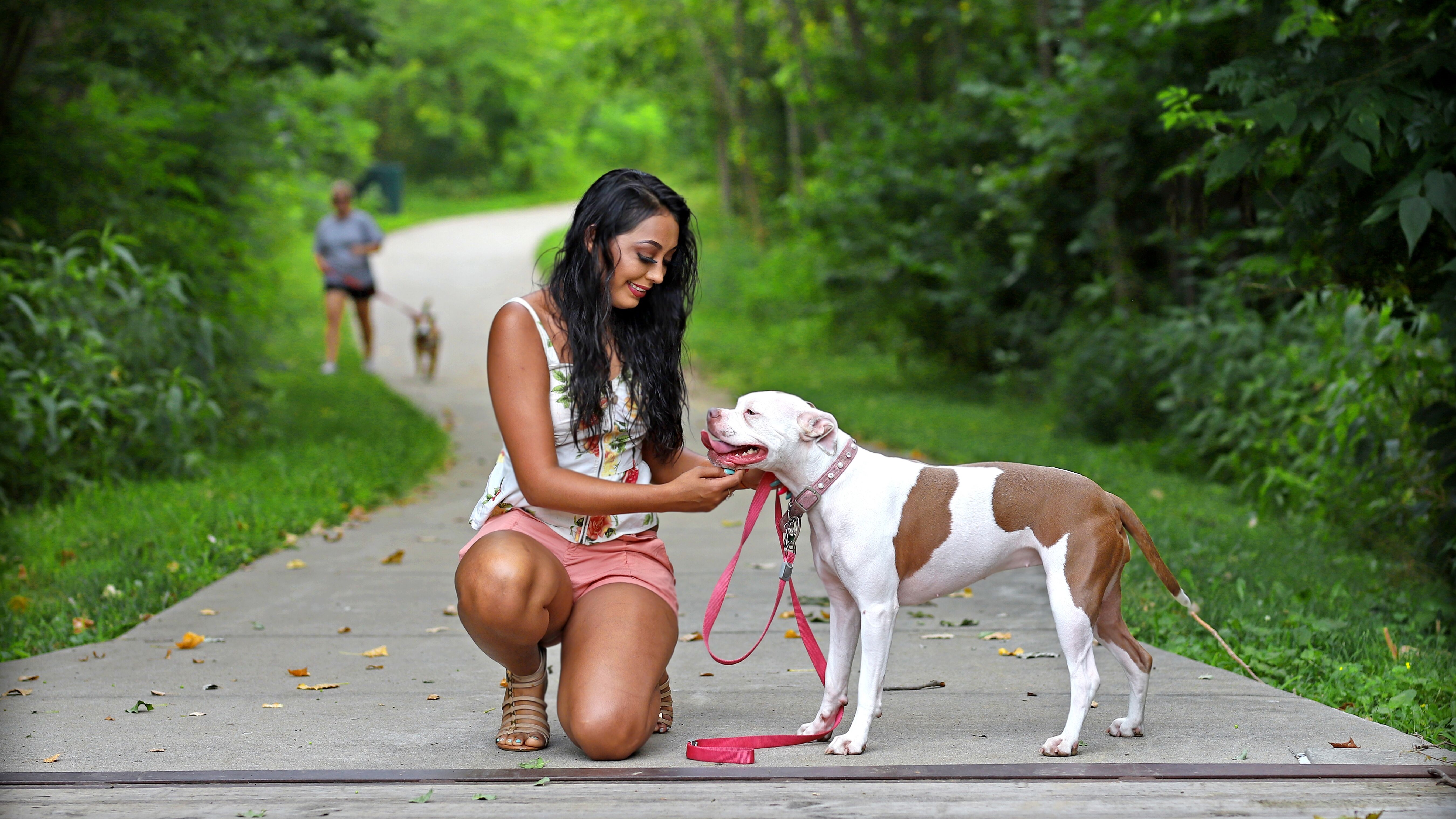 Girl petting her dog on the trail