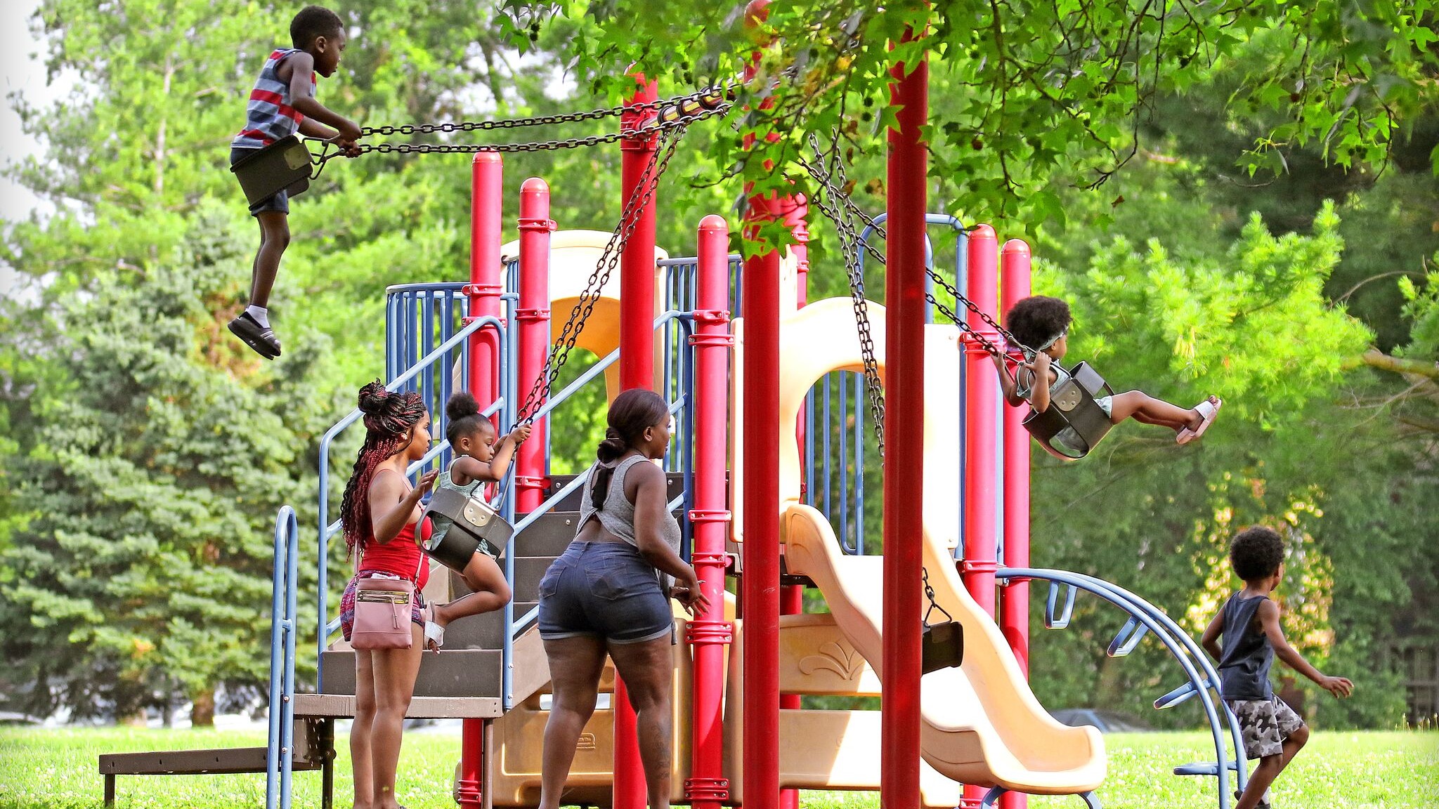 Kids on the Swings and Slides playing at Holmes park