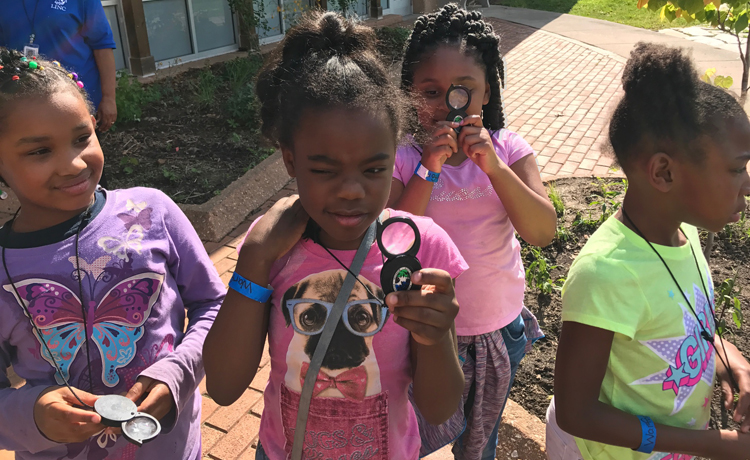 Children looking through magnifying glass