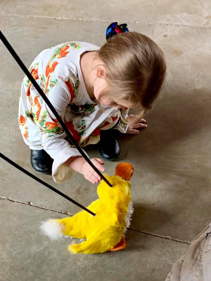 girl playing with toy duck
