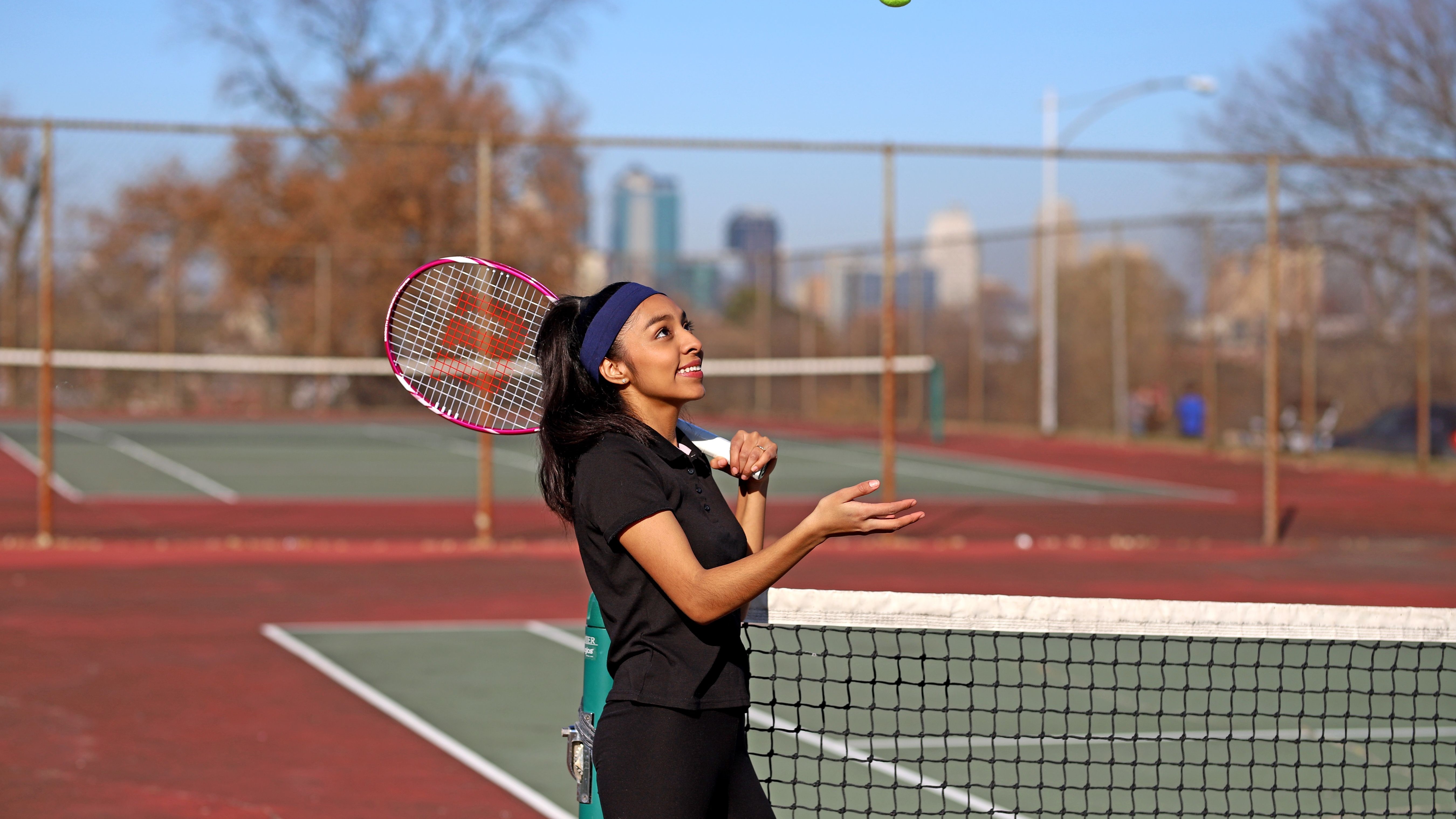Girl playing tennis in the tennis court