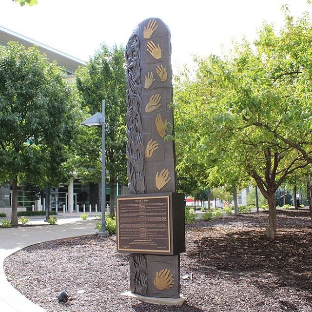 Our #WhatsThatWednesday picture is of the Bill Of Rights Monument in Ilus Davis Park. Created by: Kwan WuDedicated:September 26, 1991Medium: BronzeDescription:A bronze Bill of Rights plaque was presented to the United States District Court in conjunction with the bicentennial of the United States Constitution. After receiving the plaque, the Court began an effort to determine the best way to display the plaque. The artist, Kwan Wu, became aware of the project through the wife of Judge Scott O. Wright, who was a student of the artist at the time. Kwan Wu is an immigrant and naturalized citizen from China and so the rights granted by the Bill of Rights and the Constitution were of great importance to him.This 14-foot tall bronze monolith is curved on the sides and the top and is located in the northeast corner of Ilus W. Davis Park, across the street from the United States District Court Building. The Bill of Rights plaque is mounted on the north side of the sculpture facing the courthouse. A dedicatory plaque is on the south side of the sculpture facing the park. The monolith features 50 pairs of “hands of freedom” that were modeled by actual individuals to represent the fifty states and all Americans of all ages, races, genders and religions that helped create and continue to impact the Bill of Rights, the building block of the United States Constitution.The work was commissioned by the United States District Court and funded by donations from the judiciary and attorneys. Many legal, judicial and political figures, including Caroline Kennedy, attended the dedication ceremony. #WTW #KCParks
