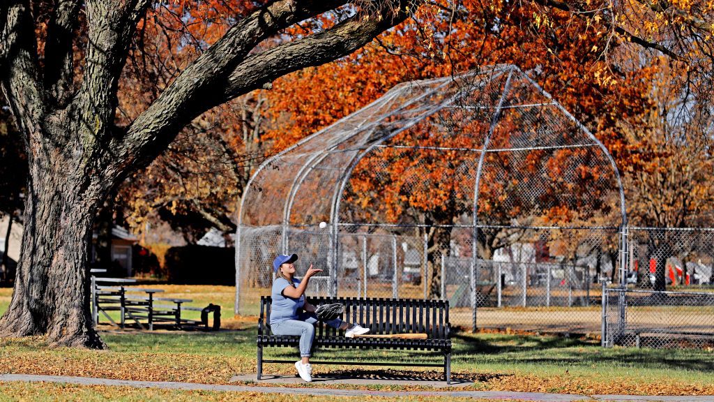 Girl with baseball gear in the park