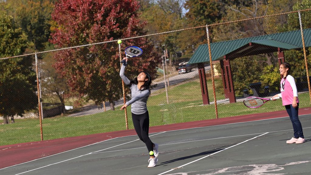 Kids playing tennis in tennis court