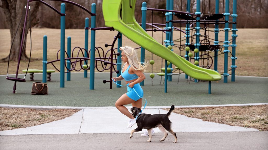 Girl Walking her dog in the park on Bannister Trail