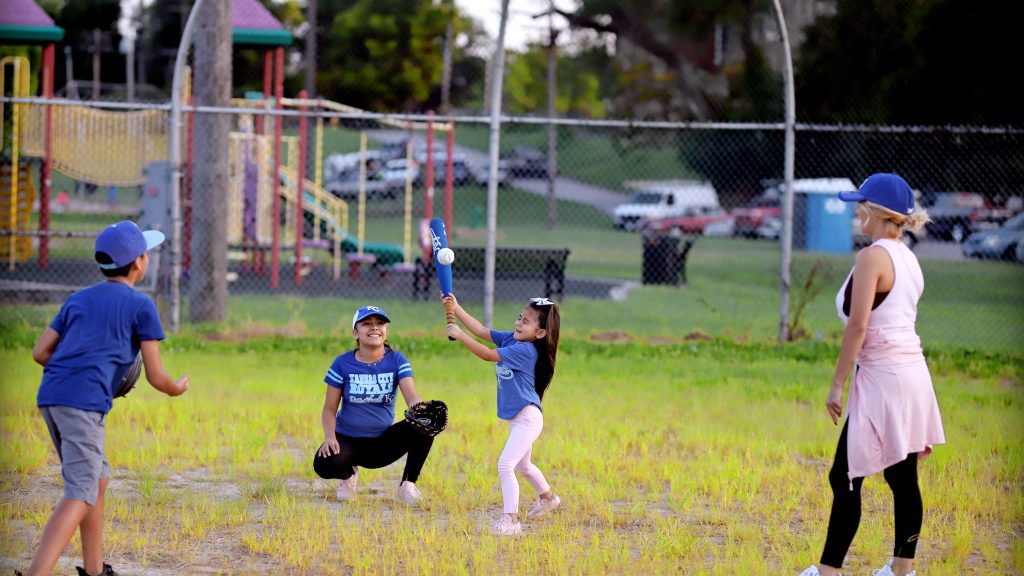 Kids playing baseball in the park