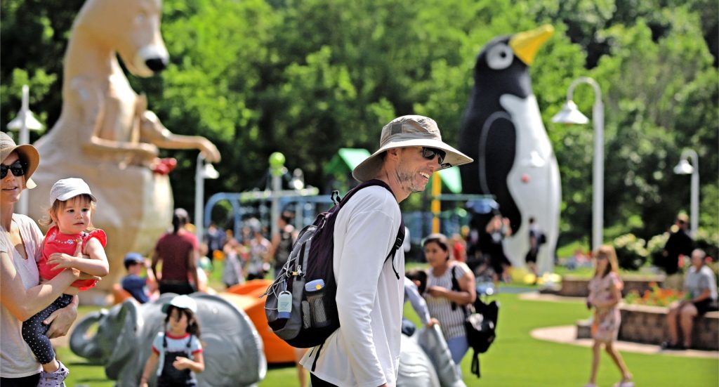 Individuals enjoying huge Penguin and Kangaroo Balloons in the Park
