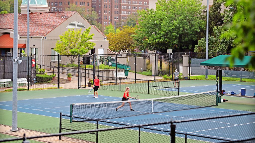 Adults playing tennis at the Plaza Tennis Center