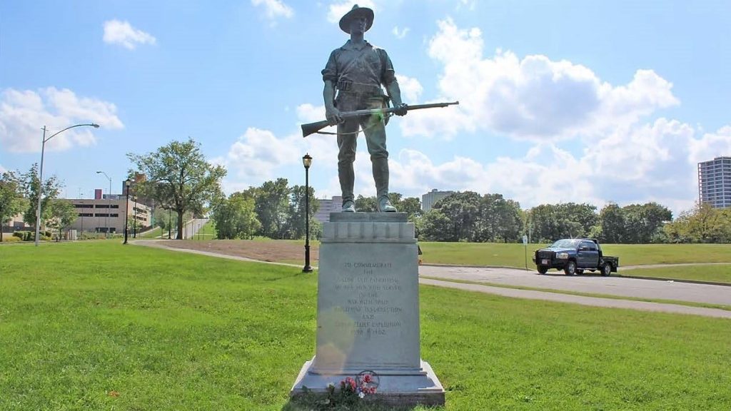 Individual with a gun statue