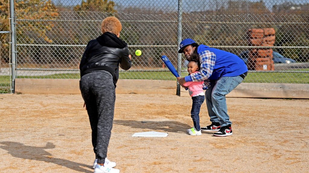 People playing baseball in the park